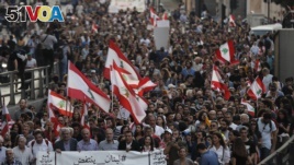 Anti-government protesters march during a protest against the central bank and the Lebanese government, in Beirut, Lebanon, Thursday, Oct. 31, 2019.