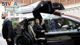 FILE - Tesla Chief Executive Officer Elon Musk gets in a Tesla car as he leaves a hotel in Beijing, China May 31, 2023. (REUTERS/Tingshu Wang)