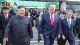 This picture taken on June 30, 2019 and released by North Korea's official Korean Central News Agency (KCNA) on July 1, 2019 shows North Korea's leader Kim Jong Un (L) meeting South Korea's President Moon Jae-in (R) and US President Donald Trump. 