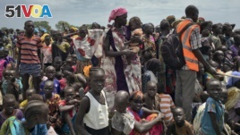 Men, women and children line up to be registered with the World Food Program for food distribution in Old Fangak in South Sudan. 