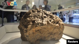 This is a piece of a meteorite that hit Russia in 2013. It was on display in Chelyabinsk, Russia in October 2013. According to local authorities and scientists, it was lifted from the bottom of the Chebarkul Lake. (AP PHOTO)