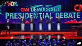 Democratic presidential candidates from left, former Virginia Sen. Jim Webb, Sen. Bernie Sanders, of Vermont, Hillary Rodham Clinton, former Maryland Gov. Martin O'Malley, and former Rhode Island Gov. Lincoln Chafee take the stage before the CNN Democratic presidential debate Tuesday, Oct. 13, 2015, in Las Vegas. On the far left is moderator Anderson Cooper.  (AP Photo/John Locher)