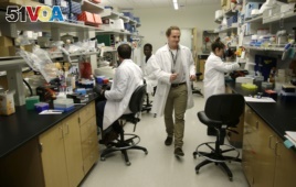 Dr. William Hahn, who is working on malaria research, walks through a research lab at the University of Washington's UW Medicine South Lake Union Campus.