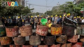 People build barricades to deter security personnel from entering a protest area in Mandalay, Myanmar, Thursday, March 4, 2021. (AP Photo)