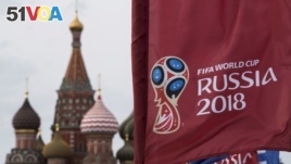 A flag with the logo of the World Cup 2018 on display with the St. Basil's Cathedral in the background, in Moscow, Russia, Monday, June 4, 2018.