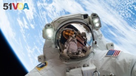 Pictured here with Earth in the background, NASA astronaut Mike Hopkins, Expedition 38 Flight Engineer, takes a spacewalk, December 2013. (Image Credit: NASA) 