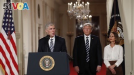 Judge Neil Gorsuch speaks as his wife Louise and President Donald Trump stand with him on stage in East Room of the White House in Washington, Tuesday, Jan. 31, 2017