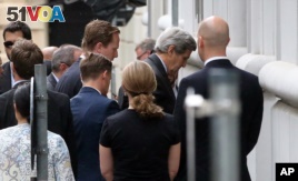 U.S. Secretary of State John Kerry, second right, arrives at Palais Coburg where closed-door nuclear talks with Iran take place in Vienna, Austria, July 8, 2015.  