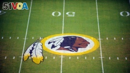 FILE - The Washington Redskins logo is shown on the field before the start of a preseason NFL football game against the New England Patriots in Landover, Md.