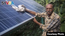 Ramanbhai Parmar, has become the first farmer to sell energy back to the power grid from the solar panels that drive his water pump in Anand district, Gujrat, India, June 8, 2015. (International Water Management Institute photo, Prashanth Vishwanathan)