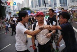 FILE - Protestors argue outside government offices in Hong Kong October 9, 2014.