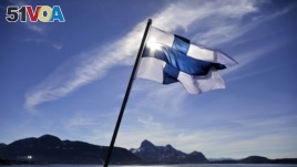 FILE - In this Saturday, July 29, 2017 file photo, Finland's flag flies aboard the Finnish icebreaker MSV Nordica as it arrives into Nuuk, Greenland. Finland has come out on top of an international index that measures nations by how happy they are as plac