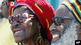 FILE - Deborah Smith and her husband, Kuma, watch festivities at a Juneteenth celebration in Los Angeles, June 19, 2010.