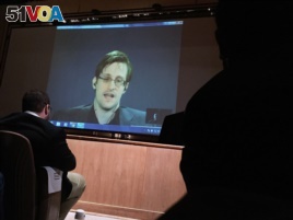 Edward Snowden, center, speaks last year via video conference.