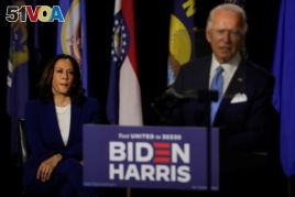 Democratic vice presidential candidate Senator Kamala Harris listens as Democratic presidential candidate and former Vice President Joe Biden speaks at a campaign event, their first joint appearance