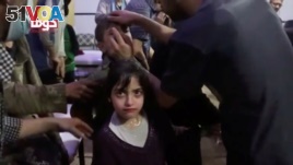 A girl looks on following alleged chemical weapons attack, in what is said to be Douma, Syria in this still image from video obtained by Reuters. (April 8, 2018.)