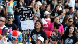 Demonstrators protest during a strike against Brazilian Social Welfare reform project, in Curitiba, Brazil March 15, 2017. The placard reads: 
