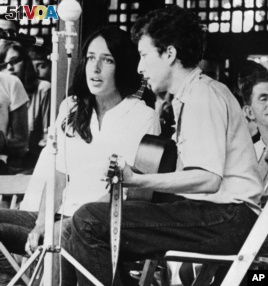 In this 1963 file photo, Joan Baez and Bob Dylan perform at the Newport Jazz Festival in Rhode Island.