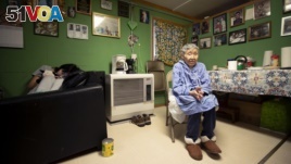 In this Monday, Jan. 20, 2020 image, Lizzie Chimiugak, right, looks on at her home in Toksook Bay, Alaska. Chimiugak, who turned 90 years old on Monday, is scheduled to be the first person counted in the 2020 U.S. Census on Tuesday. (AP Photo/Gregory Bull)