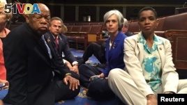 A photo tweeted from the floor of the U.S. House by Rep. Donna Edwards (R) shows Democratic members of the U.S. House of Representatives, including herself and Rep. John Lewis (L) staging a sit-in on the House floor. (REUTERS/Rep. Donna Edwards/Handout)