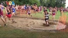 High school runners jump into a mud pit during a recent event in Texas.