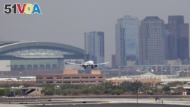Heat waves appear across the tarmac at Sky Harbor International Airport, as downtown Phoenix stands in the background as an airplane lands, Tuesday, June 20, 2017 in Phoenix. An excessive heat warning was in place over the weekend (AP Photo/Matt York)