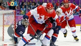 Russia forward Yevgeni Malkin seals off the puck from USA defenseman Ryan McDonagh in the first period of a men's ice hockey game at the 2014 Winter Olympics, Saturday, Feb. 15, 2014, in Sochi, Russia. (AP Photo/Mark Humphrey, File)
