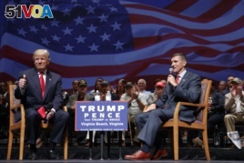 FILE - Donald Trump with Michael Flynn during a town hall in Virginia Beach, Va., Sept. 6, 2016.