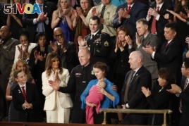Albuquerque Police Officer Ryan Holets and his wife Rebecca acknowledge their introduction by President Donald Trump as they stand with first lady Melania Trump during the State of the Union address