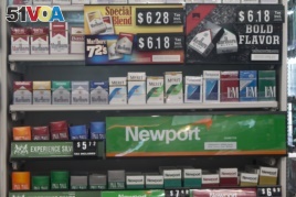 Packs of cigarettes are offered for sale at a convenience store in Helena, Mont., on Thursday, May 18, 2017.