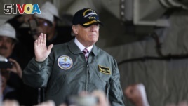 President Donald Trump aboard a Naval ship on Thursday.