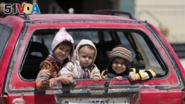 Children sit in a car in Benghazi, Libya. UNICEF says nearly 200,000 children in Libya need clean water, and more than 300,000 need educational support.