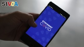 A man shows the contact tracing app Stayaway Covid on his cellphone, in Lisbon, Thursday, Sept. 17, 2020. The smartphone app uses Bluetooth technology to help discover whether people have been in close proximity to someone infected with COVID-19. (AP Photo)