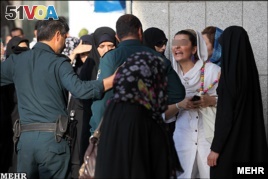 Moral Police (Ghasht e Ershad) tackle a violation of Islamic dress code in Iran in 2014.