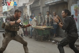 This image released by Netflix shows Chris Hemsworth, left, in a scene from 