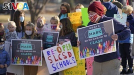 FILE - Students who attend Salt Lake City School District schools rally at East High School Monday, Dec. 7, 2020, in Salt Lake City, urging the school board and administrators to resume in-person learning. (AP Photo/Rick Bowmer)
