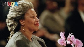 FILE - In this April 5, 1994, file photo, Toni Morrison holds an orchid at the Cathedral of St. John the Divine in New York. (AP Photo/Kathy Willens, File)