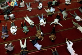 Muslim men nap as they wait for the time to break their fast after Friday prayer at the Istiqlal Mosque in Jakarta, Indonesia, Friday, June 9, 2017.