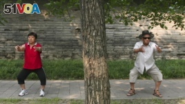 These people are doing a traditional form of Chinese exercise in a Beijing park, 2008. (Reuters/Grace Liang)