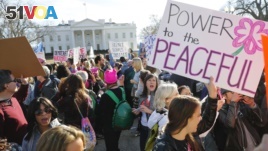 FILE - Women's March demonstrators walk past the White House in Washington, Jan. 20, 2018. (AP Photo/Pablo Martinez Monsivais)
