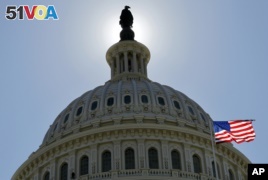 The US flag flies next to the Capitol in Washington, as Americans prepare for the deadline of the 2015 income tax season.
