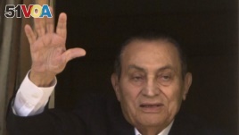 Ousted former Egyptian President Hosni Mubarak waves to his supporters from his room at the Maadi Military Hospital, where he is hospitalized, as they celebrate Sinai Liberation Day that marks the final withdrawal of all Israeli military forces from...