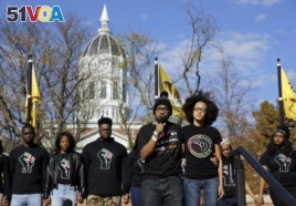 In this 2015 photo, graduate student and member of a black student group Jonathan Butler, center, speaks to a crowd during a demonstration at the University of Missouri.