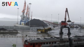 Coal brought from Siberia are be seen awaiting loading onto a ship bound for China in the North Korean special economic zone of Rason. 