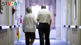 In this Nov. 6, 2015 file photo, an elderly couple walks down a hall in Easton, Pa. Research released on Friday, Nov. 1, 2019 suggests many American adults inaccurately estimate their chances for developing dementia and do useless things to prevent it. 
