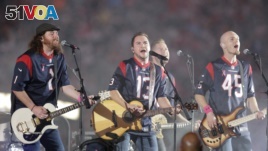 FILE - This Oct. 9, 2014 file photo shows The Eli Young Band performing during halftime of an NFL football game in Houston. The band will perform as part of the Concert in Your Car series at the new Texas Rangers stadium in Arlington, Texas starting June June 4. (AP Photo)
