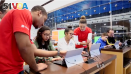  Students learning computer programming skills at a Microsoft store in New York City.