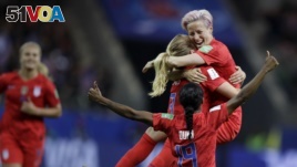 United States' scorer Samantha Mewis lifts her teammate Megan Rapinoe as she celebrates her side's 4rth goal during the Women's World Cup soccer match between United States and Thailand June 11, 2019. (AP Photo/Alessandra Tarantino)