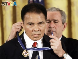 FILE - President George W. Bush presents the Presidential Medal of Freedom to boxer Muhammad Ali in the East Room of the White House, Nov. 9, 2005.