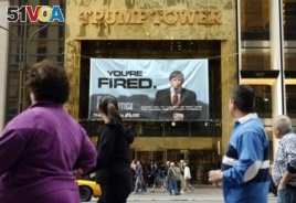 FILE - In this Saturday, March 27, 2004 file photo, passersby look at a sign advertising the reality television show, 